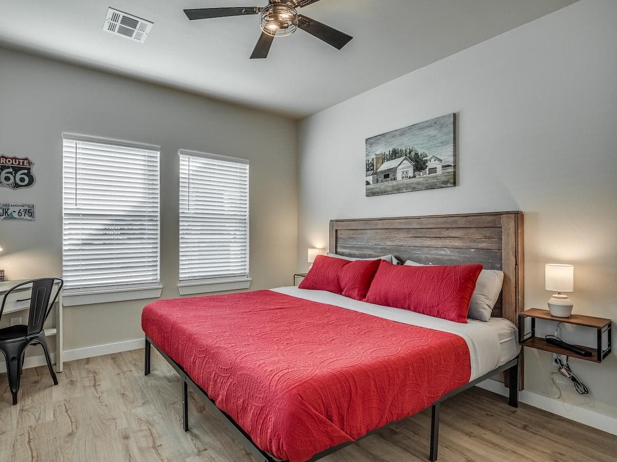 Primary bedroom includes small dresser, full length mirror, ceiling fan, box fan, extra sheets and pillows, and a desk.

Both sides of the bed contain a floating nightstand, power strip, and lamp.